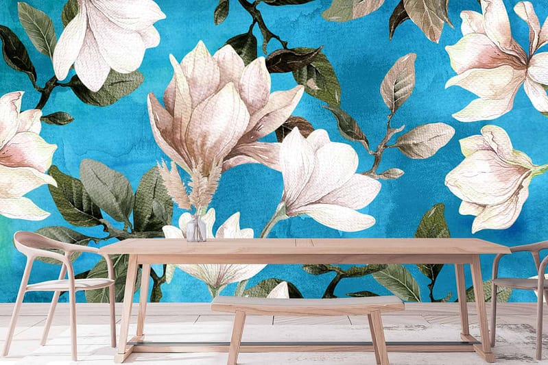 The wallpaper features a vibrant blue backdrop adorned with large white and pink magnolia blossoms and green leaves.