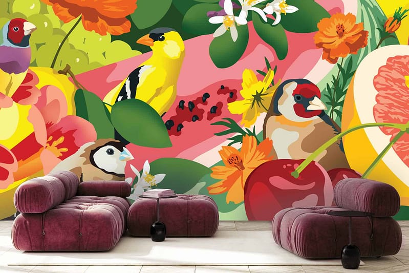 Bright, colorful wall mural features vibrant abstract birds, flowers, and fruits. Key elements include tropical birds in vivid blues and yellows, bold red flowers, lush green foliage, ripe oranges and berries in striking reds and purples. The backdrop is a dynamic mix of swirling patterns with splashes of teal, magenta, gold accents creating an energetic scene.