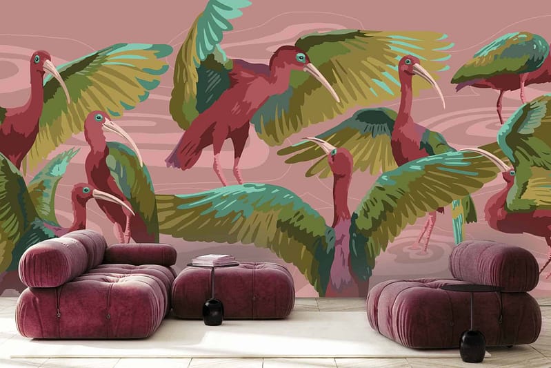 The wallpaper features a vibrant wall mural with stylized ibises showcasing red bodies and green wings. The background is pink with abstract patterns, adding artistic flair to any room.