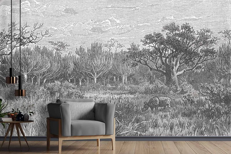 The wallpaper in the modern living room features a large, detailed black-and-white mural. It depicts a serene forest scene with trees, various types of foliage, and grazing animals. The intricate design captures elements of nature in tranquil detail.