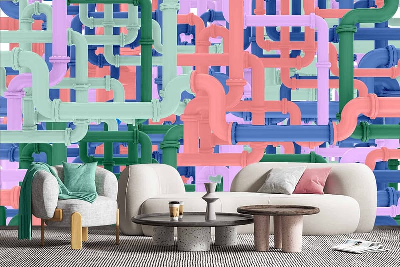The wallpaper is a colorful mural with intertwined pipes in green, pink, blue, and purple hues. Eclectic design. Vibrant atmosphere.