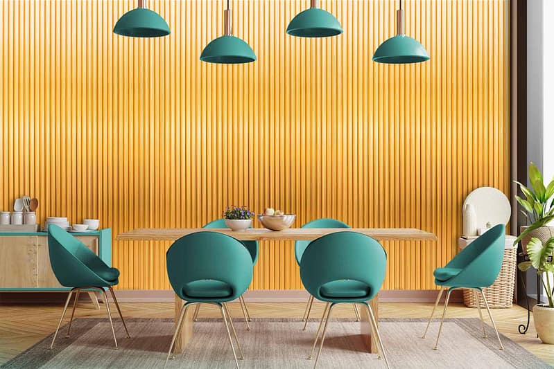 The textured gold wallpaper in the modern dining area features an intricate pattern that exudes elegance. Its rich golden hue complements the green pendant lights and lush plant decor, creating a luxurious backdrop.