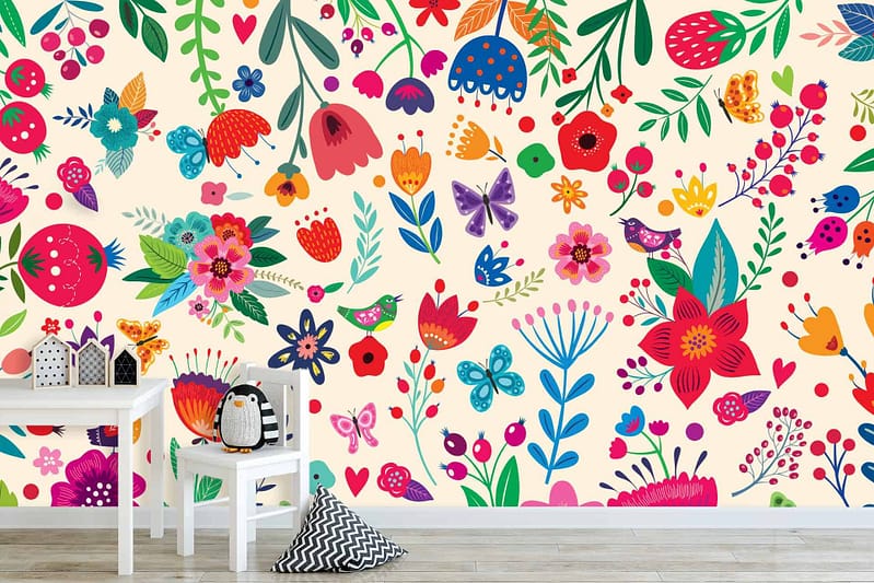 A vibrant children's room wall mural filled with a mix of whimsical flowers, green leaves, fluttering butterflies, chirping birds, and cheerful hearts. Bright colors include vivid reds, blues, yellows, and pinks interspersed with softer pastels.