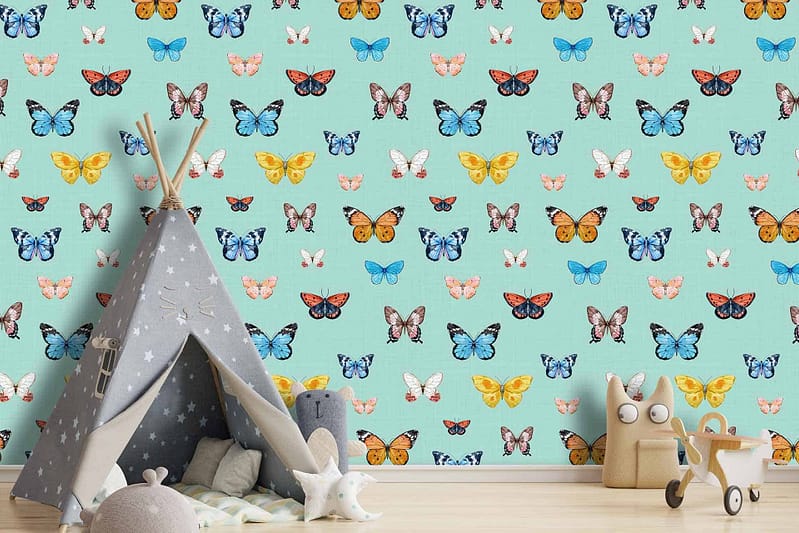 A children's room with a light blue wall adorned with colorful butterfly patterns.