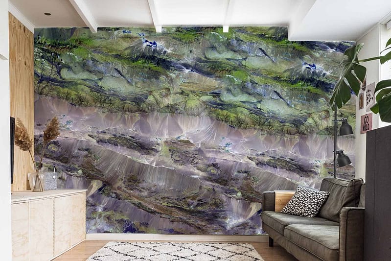 The wall mural features a nature-inspired abstract design with vibrant green and earthy tones, including shades of forest green, moss, olive, brown, and beige.