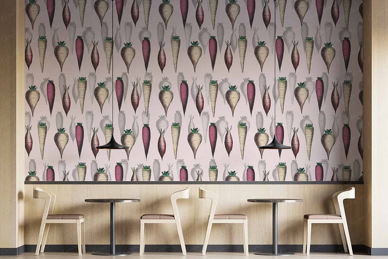 The wallpaper features vibrant carrot-shaped designs with lush green tops, creating a whimsical yet natural feel reminiscent of Nottingham Forest greenery. The carrots are placed against a light background, highlighting hues of orange, green, and subtle earth tones. This playful pattern breathes life into the contemporary space with its modern touch.