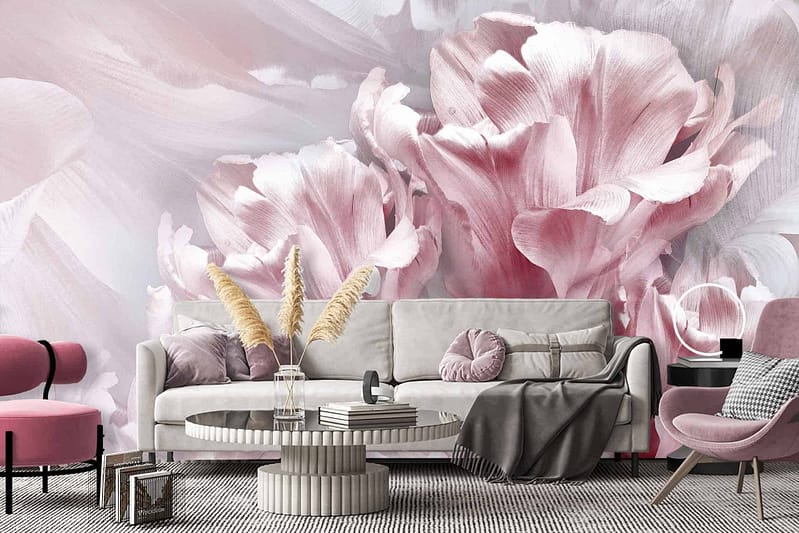 A modern living room features a large floral mural wallpaper dominated by soft pink and white tones. The design showcases intricate floral patterns, blending various shades of pink with delicate white accents. The flowers are detailed and create a serene and elegant atmosphere in the room. This stunning backdrop is the focal point, enhancing the overall aesthetic with its graceful blend of pastel hues. Perfect for searches related to "soft pink floral wallpaper," "white and pink flower mural," or "elegant floral wall design.