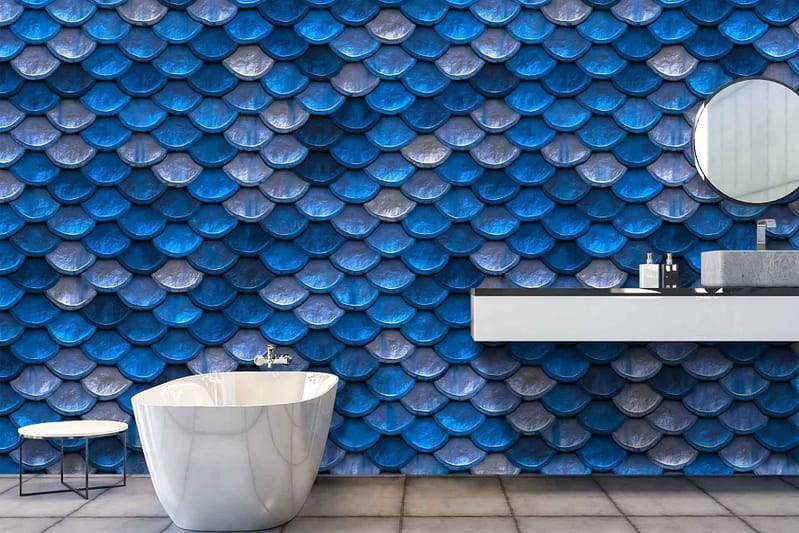Modern bathroom with a striking blue and gray scalloped tile wall, exuding serene coastal vibes.
