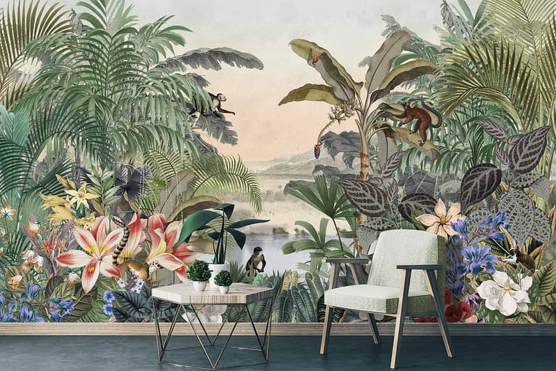 The mural wallpaper showcases a lush tropical jungle teeming with vibrant flowers in shades of pink, red, and yellow. Various plants such as ferns, palms, and large-leafed greenery cover the background. A playful monkey swings from a vine while a colorful bird perches on a branch nearby. The serene landscape includes subtle gradients of green with hints of blue to depict distant foliage and sky. The rich palette includes deep greens, bright floral hues, earthy browns from tree trunks and branches, complemented by pops of vivid bird plumage in reds, blues, and yellows.
