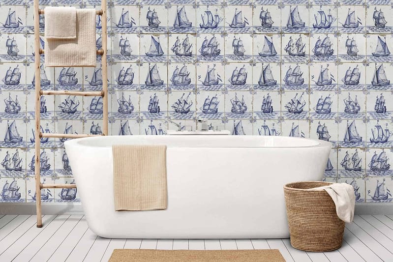 The wallpaper features tiles with blue sailing ships, contributing a nautical charm to the bathroom.