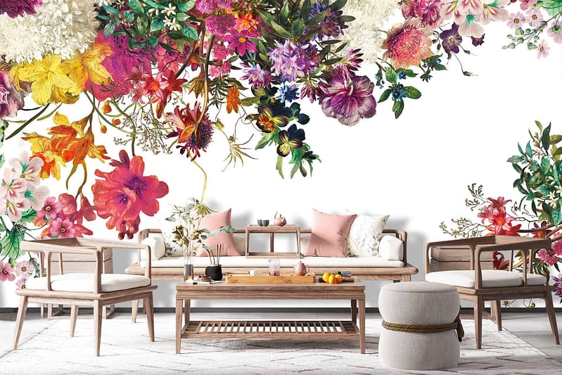 The wallpaper in this modern living room reimagined as a paradise features a vibrant floral design. It includes colorful flowers such as daisies, roses, and peonies. The richly detailed blooms come in hues of pinks, reds, yellows, and whites against a lush green backdrop. Elements like intricate petals and verdant leaves create an idyllic scene that transforms the space into a floral oasis.