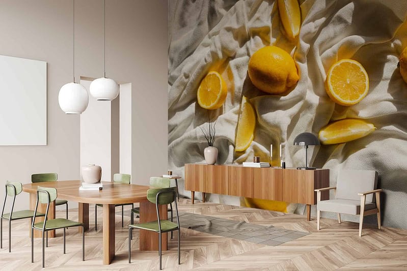 Large wall mural features still life with lemons on draped fabric. Elements include vibrant yellow lemons, green leaves, and intricate folds of fabric in shades of white and soft gray.