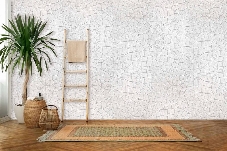 The wallpaper is a cracked white mosaic, hinting at gentle erosion. The cracks and subtle wear add texture and depth to the clean, white surface.