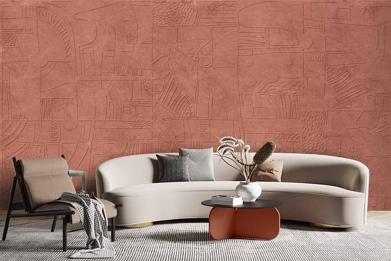The wallpaper features a textured, terracotta geometric pattern inspired by Indonesian designs. It consists of warm, earthy tones with intricate shapes and motifs. Elements include repeating triangles, diamonds, and lines forming an elaborate tapestry-like effect. Colors are primarily terracotta with accents of muted orange and deep clay hues.