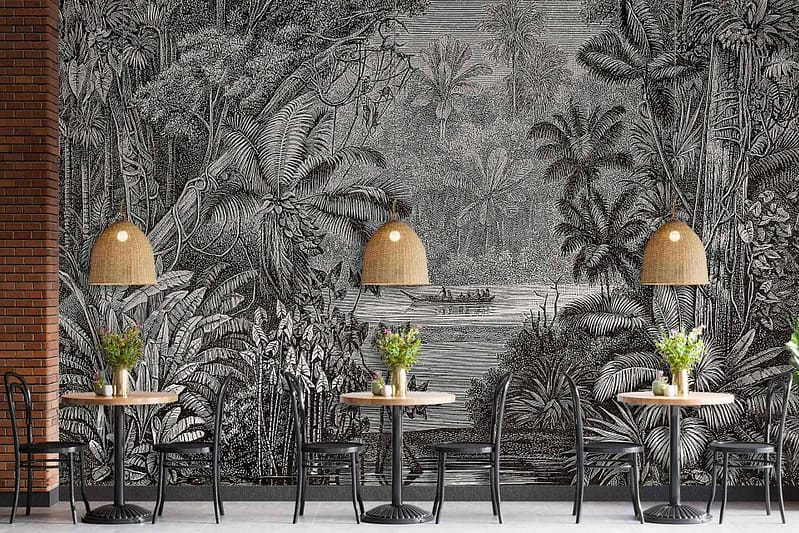 Monochrome jungle-themed mural reminiscent of Curious George’s adventures. Features detailed flora and fauna in shades of black, white, and gray. Includes intricate patterns of leaves, vines, and whimsical animal illustrations.