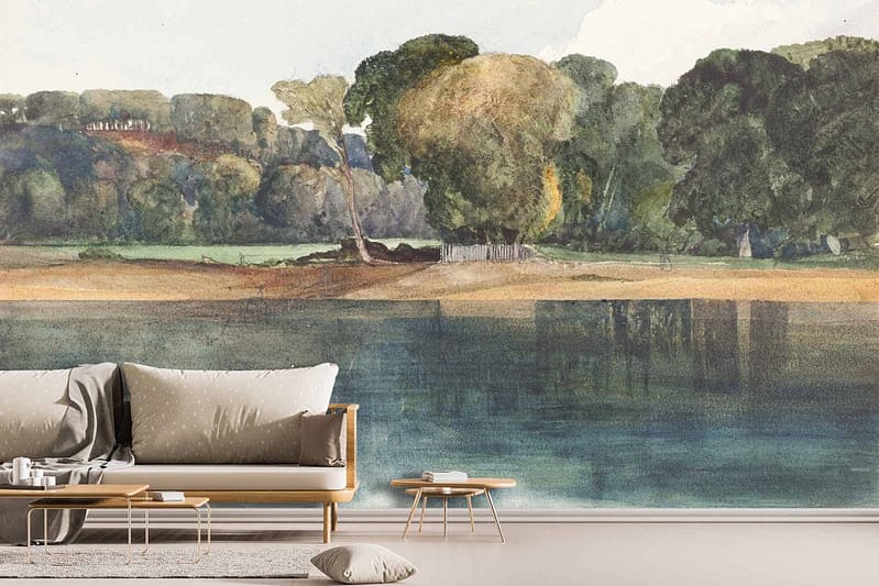 The wallpaper features a serene lakeside landscape with calm waters, lush green trees, a fallen tree by the shore, and a peaceful sky. Predominant colors are shades of blue for the water and sky, various greens for the foliage, and brown tones for the fallen tree.