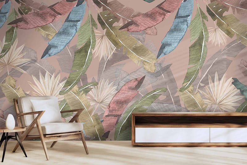 The wallpaper boasts a fantastical tropical leaf pattern, featuring shades of green, blue, pink, and beige. This vibrant design evokes an exotic paradise with its intricate foliage and dynamic color palette. The lush green leaves intermingle with pops of soothing blue and soft pink hues, all set against a neutral beige backdrop to create a striking yet harmonious visual experience.