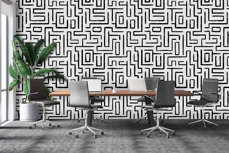 Black and white geometric patterned wall. Angular shapes, interlocking lines. Predominantly monochromatic with bold contrasts.