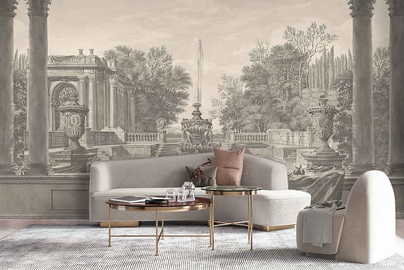 The wallpaper in this stylish living room features an intricate mural of the Fountain of Youth amidst classical architecture and lush gardens. Key elements include detailed classical columns, flowing water from the fountain, vibrant green foliage, and ornate stonework. Colors predominantly include rich greens, soft blues, warm terracotta tones, creamy whites, and subtle gold accents.