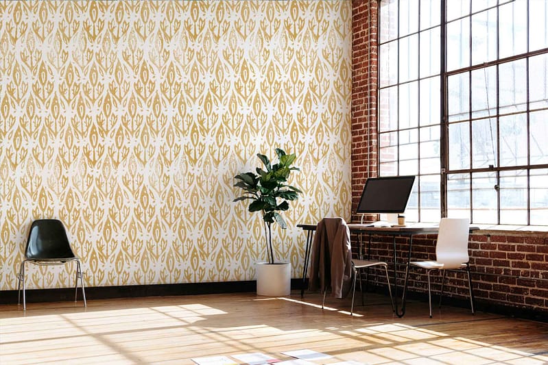 Patterned yellow wallpaper with intricate designs. The wallpaper features shades of mustard yellow, gold, and touches of white detailing. It has floral and abstract motifs that create a vibrant yet classic ambiance.