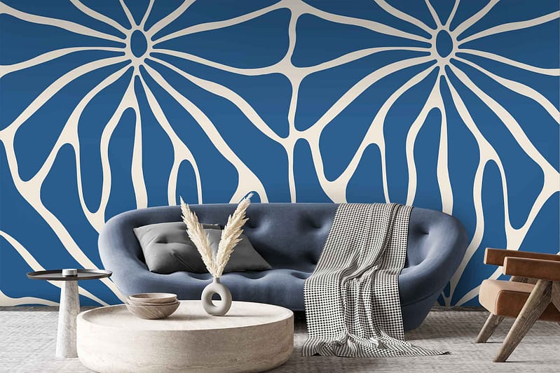 The wallpaper is a bold blue and white abstract floral pattern, featuring dynamic, sweeping designs that create a lively visual interest. The deep blue hues contrast strikingly with crisp white elements, bringing in an artistic and modern flair that ties the room's decor together seamlessly.