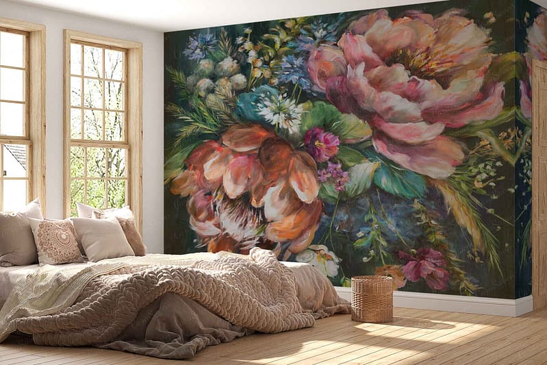 A large, colorful floral mural adorns the wall, featuring vibrant blooms in hues of red, pink, blue, and yellow. Green leafy accents intertwine among the flowers. The background is a soft cream color, enhancing the richness of the floral patterns. This lively wallpaper brings nature indoors with its bold yet elegant design.