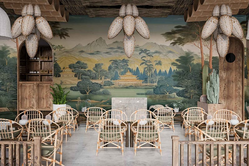 Wallpaper features a large mural with serene nature scene: mountains, trees, and a temple. Predominant colors are green for trees and plants, blue for the sky and water, brown for mountains and temple accents. Earth tones dominate the palette.