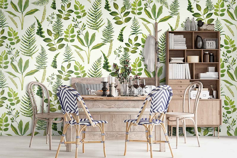 The Ming Cacti wallpaper showcases intricate patterns of lush green leaves interwoven with vibrant cactus plants. The textured design features varying shades of green, from deep emerald to light jade, accented with subtle hints of earthy browns and delicate white blossoms. This rich tapestry of botanical elements adds depth and a touch of exotic elegance to the dining room walls.