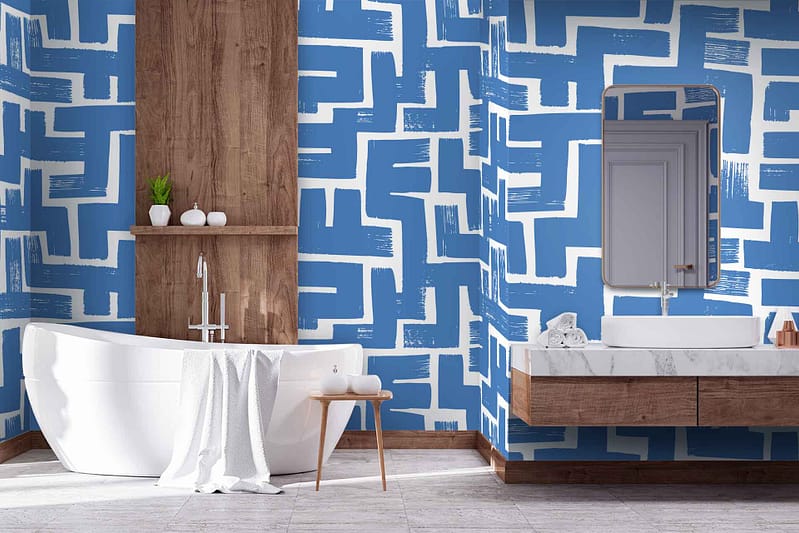 The bathroom showcases a bold blue and white geometric pattern wallpaper by The Painter, featuring striking interconnected shapes and clean lines. The vibrant blue contrasts sharply with the crisp white, creating a visually dynamic backdrop that catches the eye. The geometric elements evoke modernity and sophistication, blending seamlessly with the contemporary design of the space. This wallpaper serves as an exquisite focal point, integrating hues of azure and ivory in an unforgettably stylish manner.