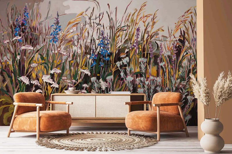 The wallpaper in the cozy living room showcases a large, colorful mural of pincushion proteas, tall grasses, and wildflowers. Key elements include vibrant pincushion proteas in shades of orange and red, lush green tall grasses, and an array of multi-colored wildflowers.