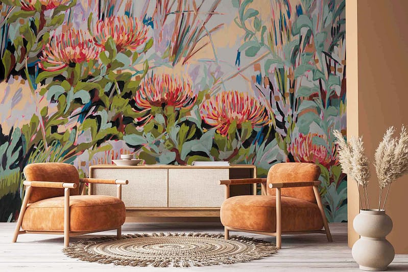The wallpaper features a vibrant floral mural with striking red and green colors. Key elements include vivid Pincushion Proteas, lush green leaves, and other bright flowers in similar hues. The design is bold and eye-catching, perfect for creating a lively atmosphere.