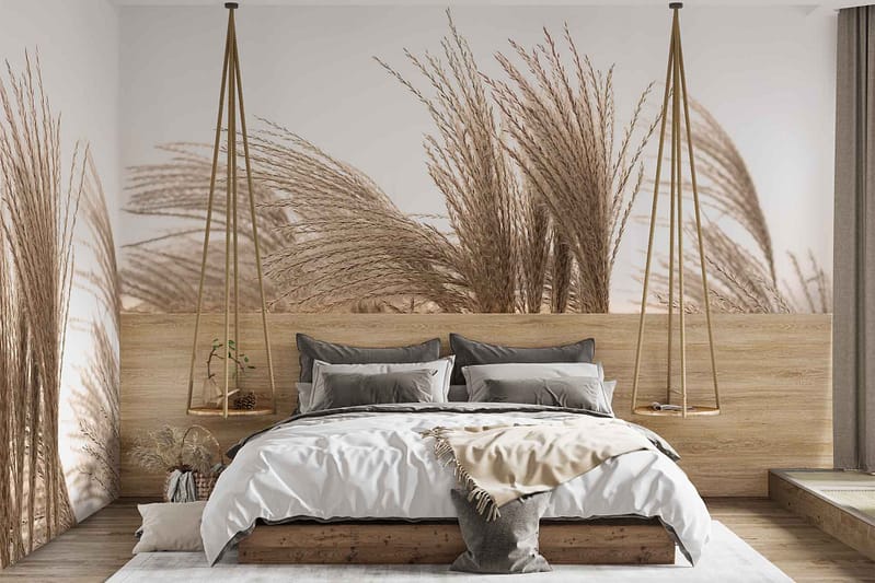 The wallpaper features a large mural of tall grasses, reminiscent of historical French fields. It emphasizes earthy tones such as muted greens, pale yellows, and soft browns. The design gives a natural, serene aesthetic to the room with its depiction of swaying grass and delicate wheat heads. Hints of gray might be present to add depth and shadowing within the grassy field image.