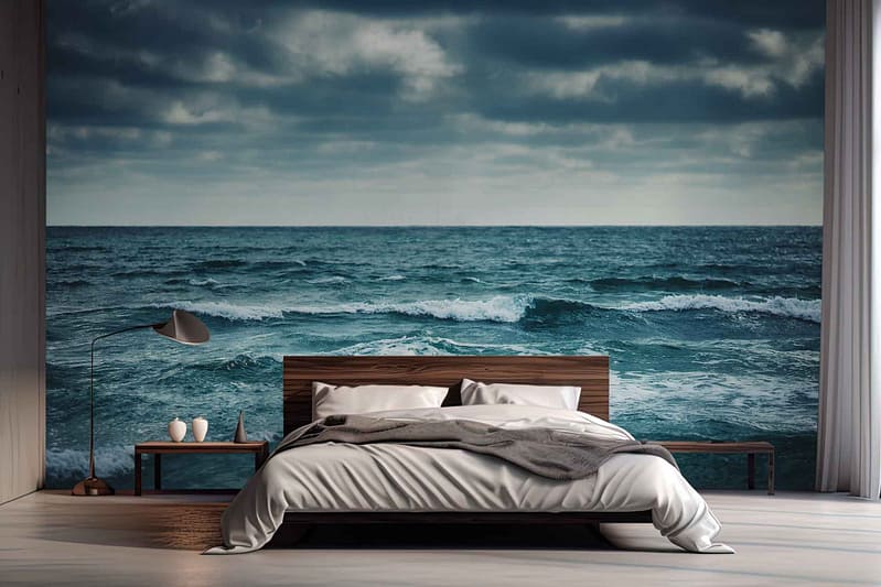 The wallpaper features a stunning, realistic mural of rough seas with deep blues and dark greys, juxtaposed against a slightly cloudy sky in soft whites and light grays. The dynamic waves create movement, while the serene sky above adds tranquility.
