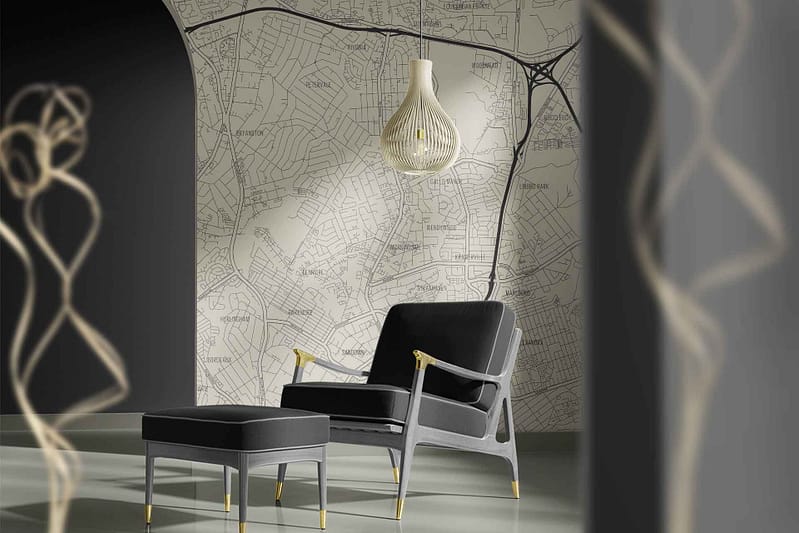 The wallpaper features a detailed map design with intricate lines and patterns. Its color palette primarily includes muted tones like beige, gold, and subtle hints of grey. This decor element exudes an elegant yet urban vibe in the north-facing space.