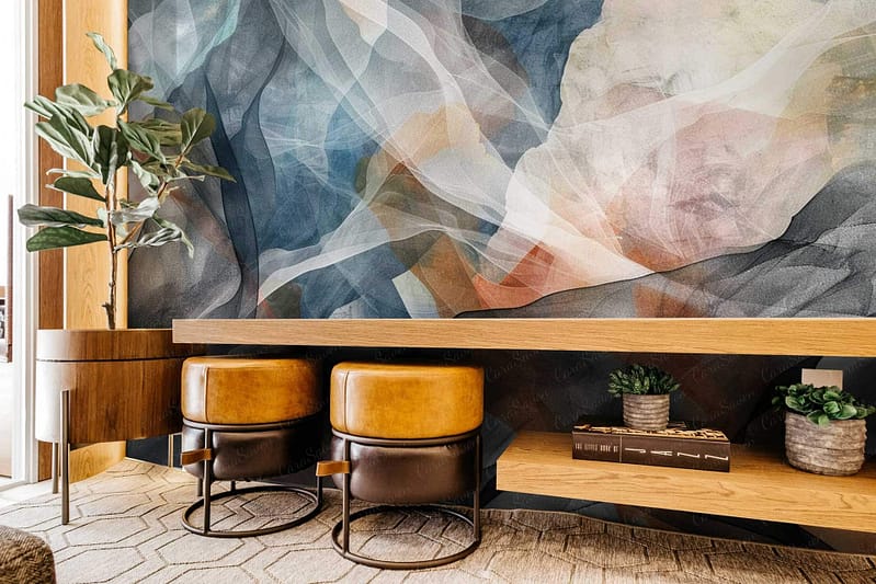 The wallpaper in the modern interior is abstract with a dynamic mix of deep indigos, muted grays, and vibrant oranges, inspired by *Fly by Night*. Shapes include intricate geometric patterns and flowing organic forms. Hints of gold add an elegant touch. Key elements: abstract pattern, deep indigo, muted gray, vibrant orange, geometric shapes, organic forms, gold accents.