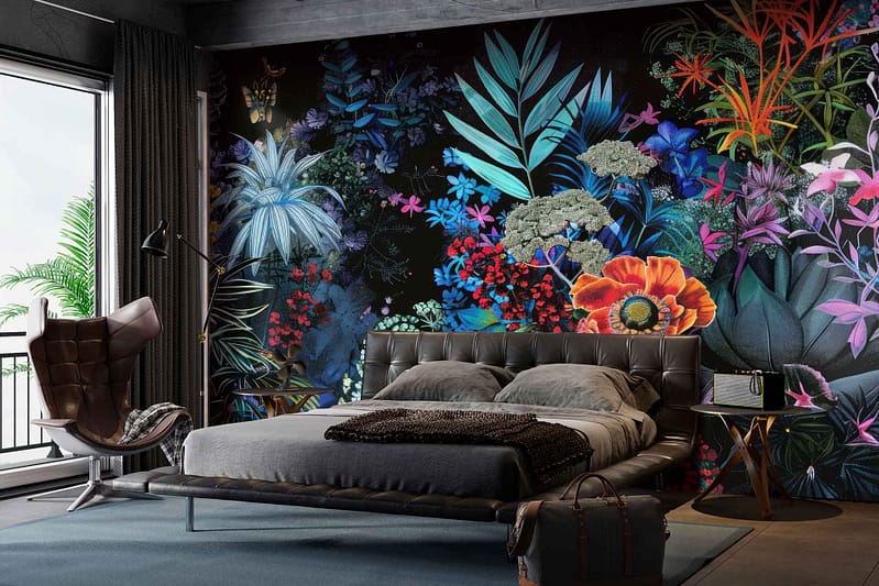 Vibrant mural of tropical plants and flowers on a dark wall. Elements include large leaves, exotic blooms, and bright colors such as greens, pinks, oranges, and yellows.