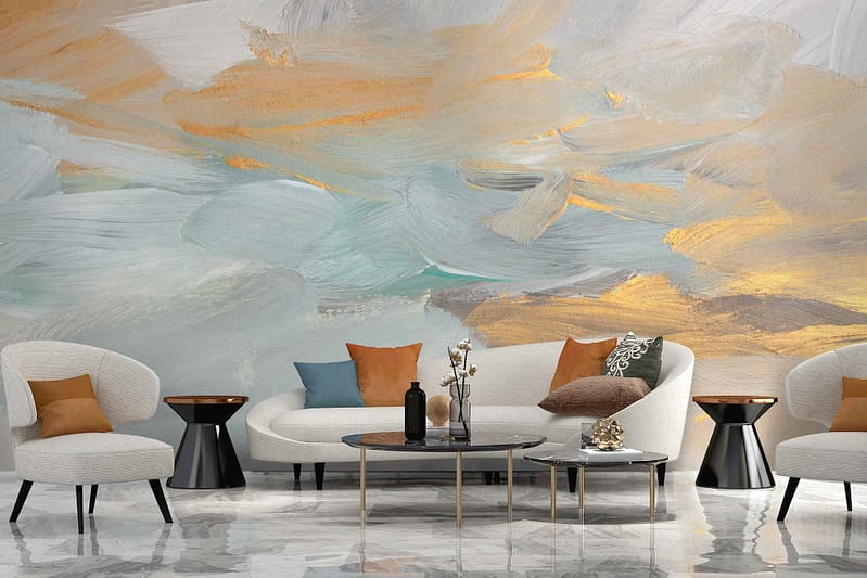 A modern living room with abstract painterly wall art in soft blues, vibrant oranges, and shimmering golds.