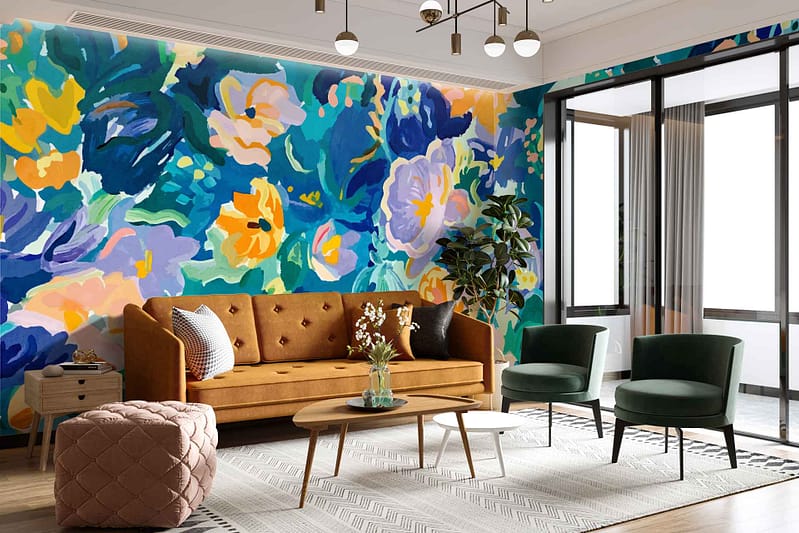 The wallpaper showcases a vibrant floral mural, featuring lush blossoms in shades of pink, red, and yellow. Green foliage intertwines with the flowers, creating a lively garden scene. The colors are bold and vivid, with intricate details highlighting petals and leaves against a subtle off-white background.