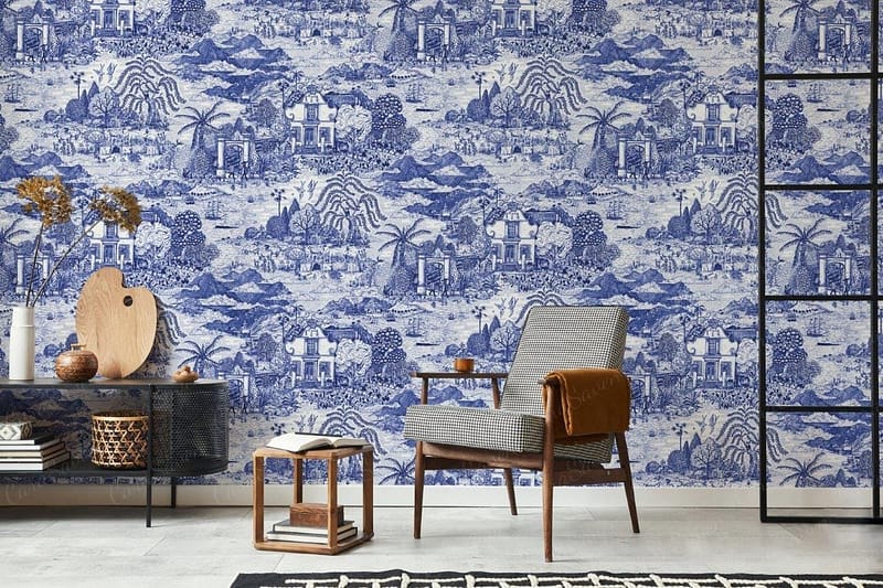 The wallpaper is a blue and white pattern, featuring scenic landscapes. It includes detailed depictions of nature, such as mountains, rivers, trees, and possibly small buildings or bridges. The primary colors are rich shades of blue contrasted against a crisp white background. Key elements include intricate illustrations of landscapes and natural scenes rendered in dual-tone blues on a plain white canvas.