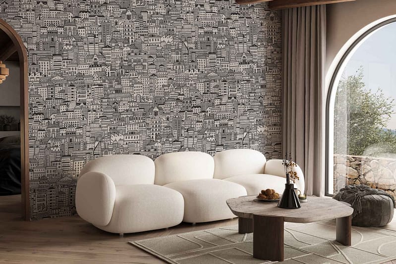 The wallpaper displays a detailed black and white cityscape mural, capturing the intricate urban fabric. It features tall skyscrapers, winding streets, historic buildings, and bustling marketplaces. The monochromatic color scheme emphasizes fine lines and stark contrasts, creating a vivid depiction of city life. Key elements include varied architectural styles and densely packed structures that reflect a classic urban landscape.