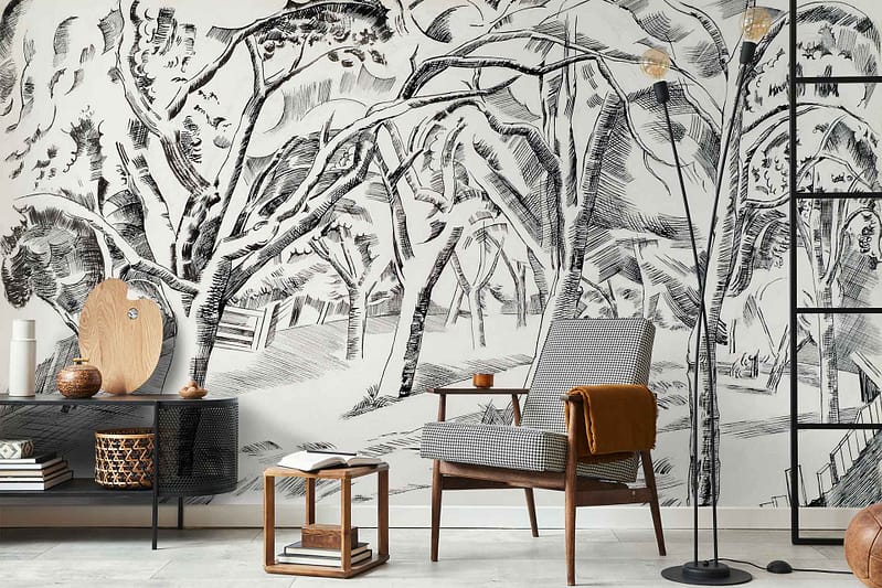 The monochrome wallpaper features a detailed tree mural that brings cool vibes to the living room. The design includes intricate black and white tree branches and leaves, creating a striking contrast. The grayscale patterns evoke a serene forest atmosphere, achieving contemporary elegance with its minimalist color palette of black, white, and various shades of gray. This sophisticated wallpaper acts as a focal point in the space while enhancing the overall modern aesthetic.
