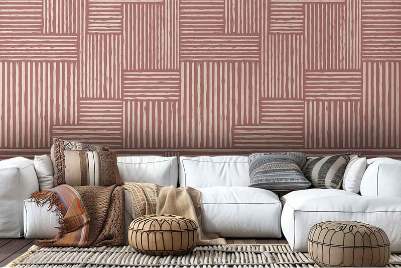 The wallpaper is a vibrant display of pink and beige stripes arranged in a geometric pattern. The alternating colors create a sense of depth and movement, with the pink hues ranging from soft blushes to bolder tones while the beige alternates between creamy and sandy shades. The geometric design of the stripes adds an intricate, almost three-dimensional quality to the wall, capturing attention immediately upon entering the room. The striking contrast between the playful warmth of pink and the subtle neutrality of beige adds both energy and balance to the space.