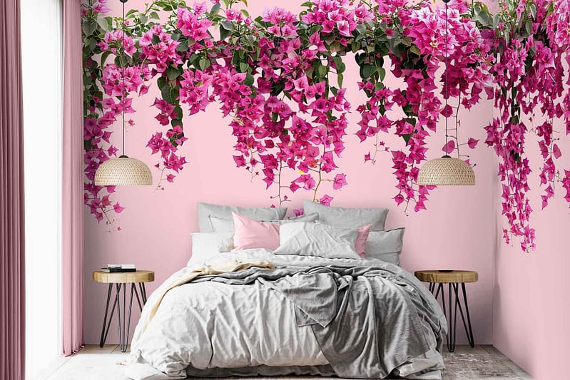 Light pink walls with a pink and green floral pattern resembling cascading bougainvillea.