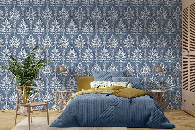 The bedroom in Ferndale features a blue and white leafy patterned wallpaper. Key elements: **blue and white**, **leafy patterns**.