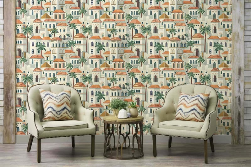 The wallpaper is a vibrant Mediterranean-style masterpiece that features intricate illustrations of buildings, palm trees, and arches. The colors in the wallpaper are a lively mix of sun-soaked yellows, rich terracottas, deep ocean blues, and lush greens. These elements come together to evoke a sense of tranquility and the spirit of Vitamin Sea. The buildings are tinged with warm hues that draw inspiration from traditional Mediterranean architecture, while the palm trees add an exotic touch with their verdant fronds waving gently against the backdrop. The arches lend an air of romance and mystery, tinted in soft pastels that complement the overall theme perfectly.