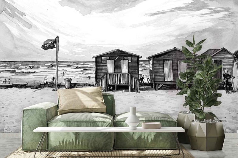 Black-and-white mural with beach huts, flagpole, shoreline, and people.