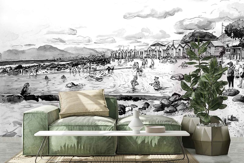 Monochrome mural featuring a busy beach scene with people, beach huts, and rocky terrain under a partly cloudy sky.