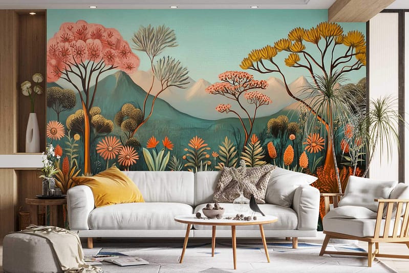 The wallpaper in the modern living room features a vibrant mural with stylized trees, plants, and mountains. It incorporates warm tones like oranges and reds for the foliage, contrasted with cool blues and greens depicting mountains and greenery. The design brings a nature-inspired atmosphere, reminiscent of a theater set backdrop. Key elements include intricate tree branches, lush plant patterns, and mountain silhouettes that blend harmoniously in this picturesque mural.