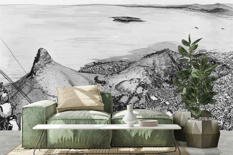 The wall mural features an aerial view of a coastal city with sprawling urban landscapes, majestic mountains, and the expansive blue sea. The color palette includes vibrant blues for the ocean, earthy browns and greens for the mountains, and various shades of gray and beige to depict the city's architecture. Splashes of white in clouds add contrast against a crisp sky.