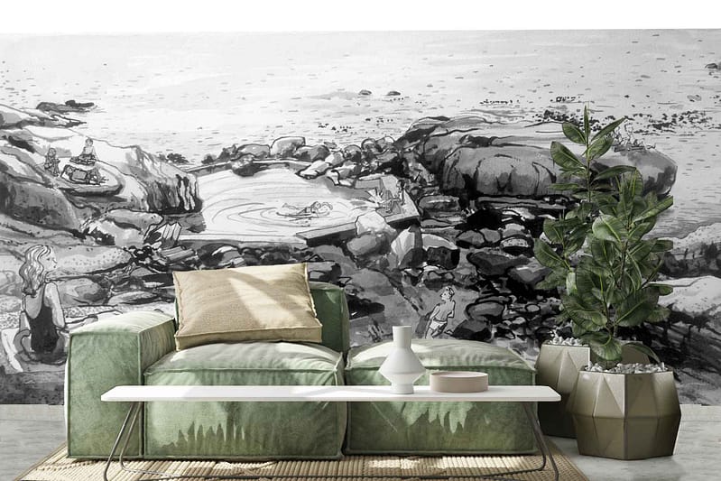 Black and white mural, rocky seaside scenery, people relaxing on rocks.